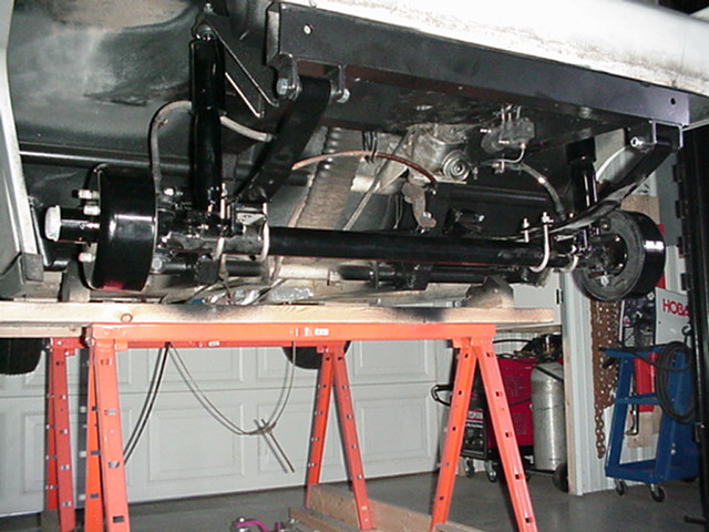 Angled view of the restored front axel assembly, steering box and brake balance in view